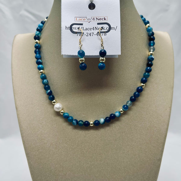 Blue beaded necklace and earrings on a mannequin bust with a visible brand tag.