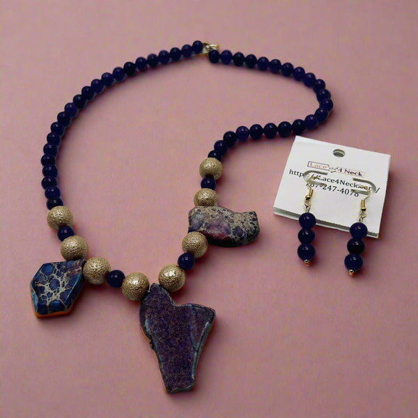 Necklace with purple and gold beads and stones on a white background
