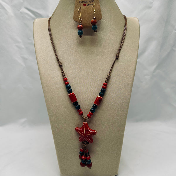 Jewelry set with necklace and earrings on a mannequin bust against a white background