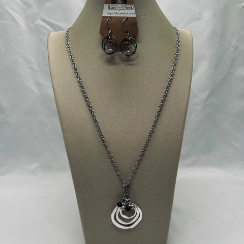Necklace and earrings on a mannequin bust with a white background