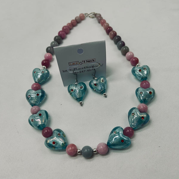Necklace and earrings set with heart-shaped blue beads and pink and gray accents on a white background.