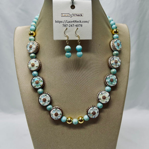Jewelry set with necklace and earrings on a mannequin bust, featuring turquoise and gold beads.
