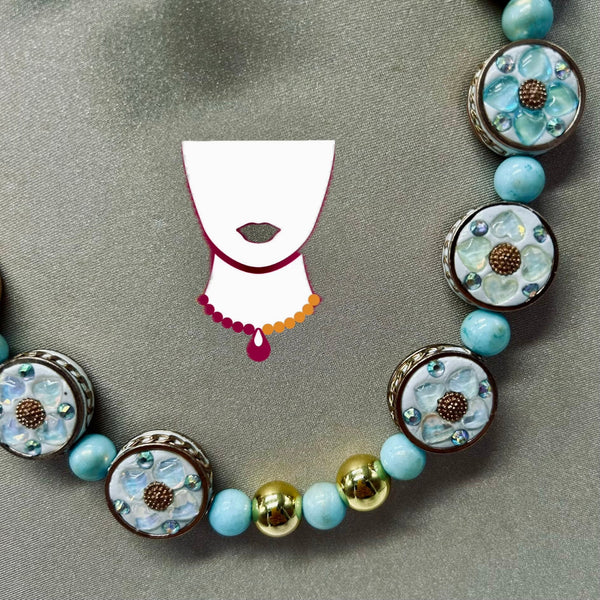 Necklace with floral and round beads on a gray background