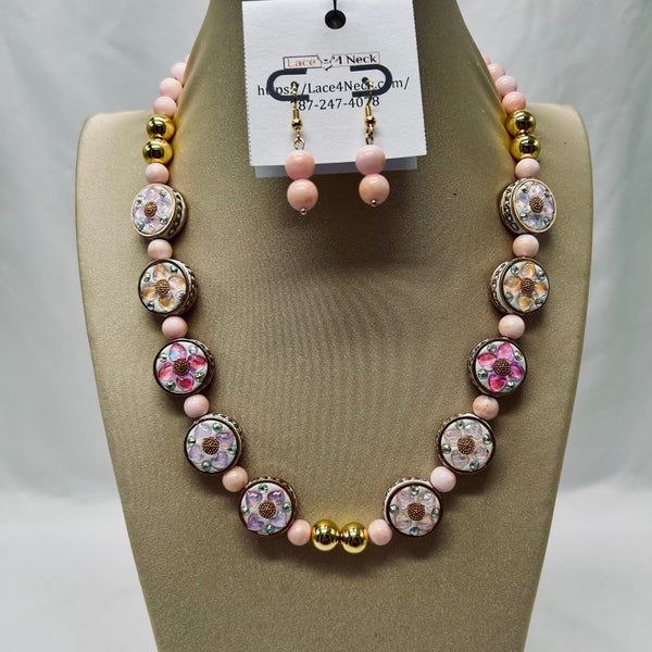 Necklace and earrings set on a mannequin bust with a visible brand tag.