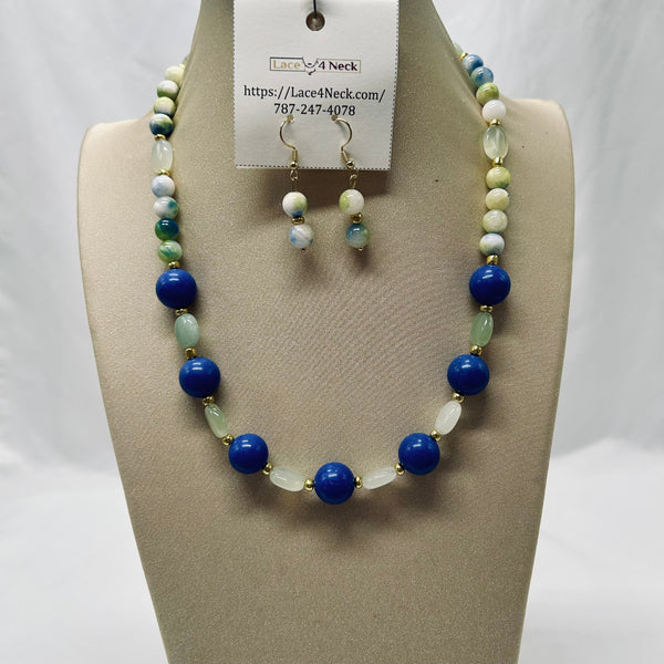 Necklace and earrings set on a mannequin with a visible brand tag.