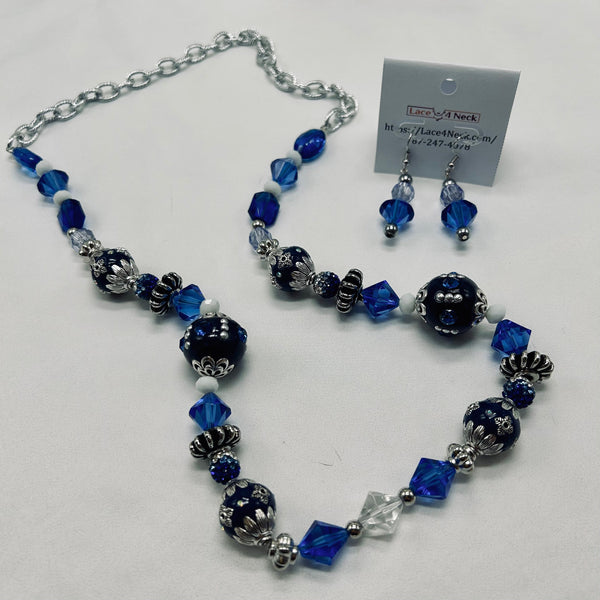 Necklace and earrings set with blue and silver beads on a white background