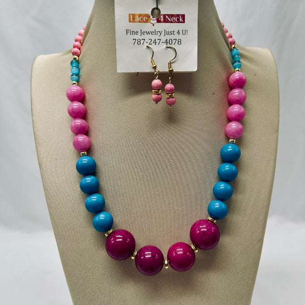 Necklace and earrings set on a mannequin bust with a visible brand tag.