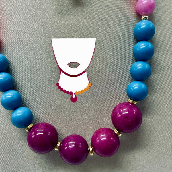Necklace with blue and purple beads on a gray background with a cartoon illustration of a face.