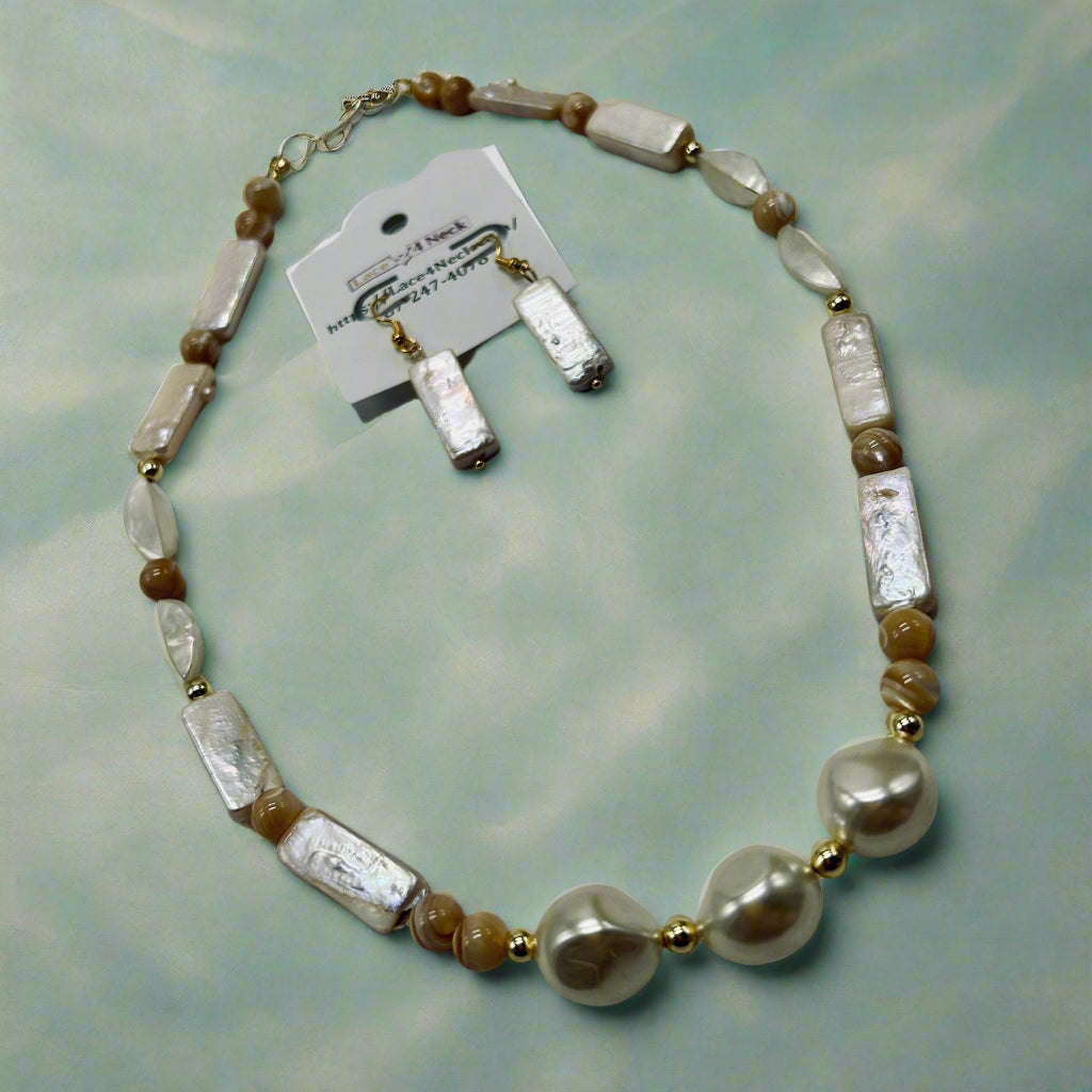 Necklace with white and brown beads on a gray surface, accompanied by matching earrings and a card.