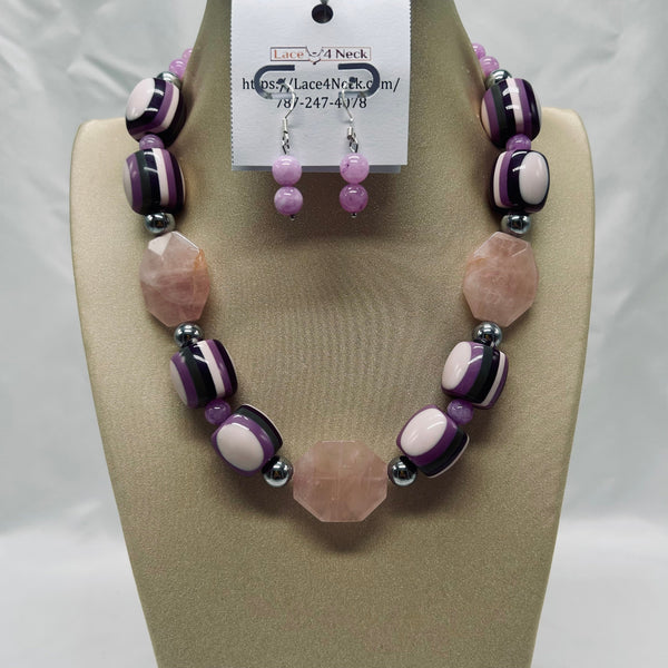 Necklace and earrings set on a mannequin with a visible brand tag.