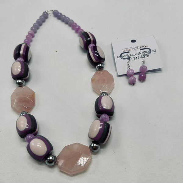Necklace with purple and pink beads on a white background