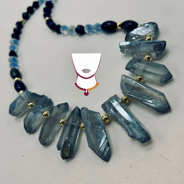 Necklace with blue crystal pendants on a light gray background