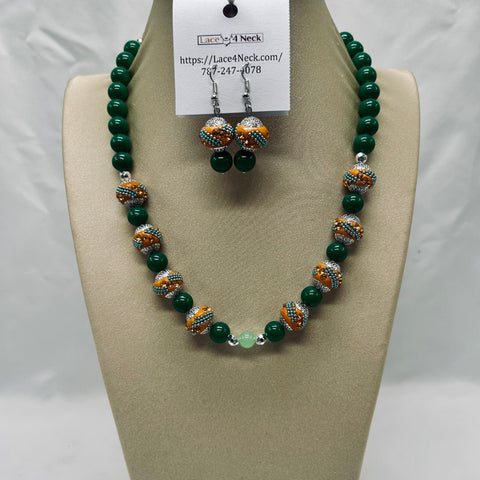 Green beaded necklace and earrings on a mannequin bust with a visible brand tag.