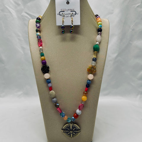 Colorful beaded necklace and earrings on a tan display stand with a white background