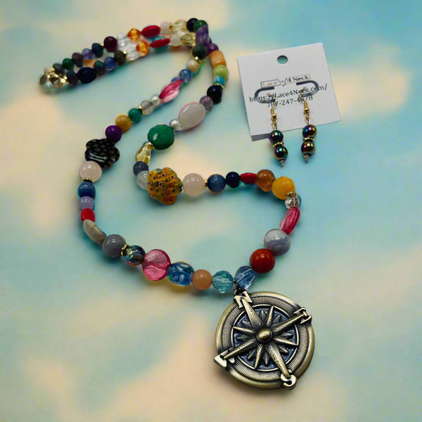 Colorful beaded necklace with a compass pendant on a white background