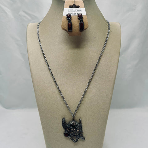Necklace with an owl pendant on a mannequin bust against a plain background