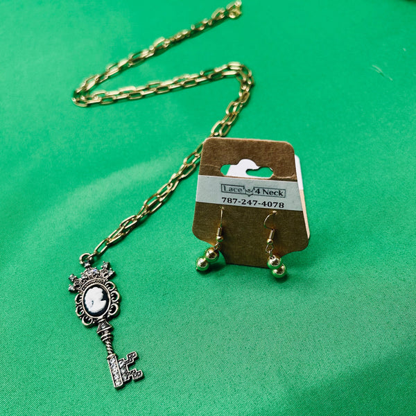 Jewelry set with necklace and earrings on a green background