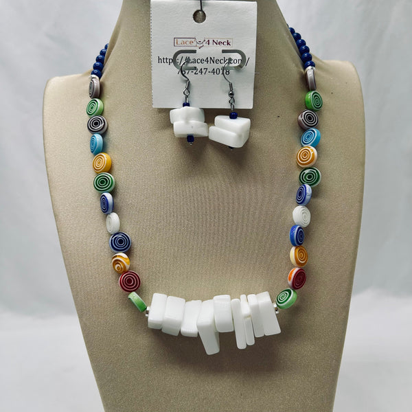 Colorful beaded necklace and white earrings on a mannequin bust with a visible brand tag.