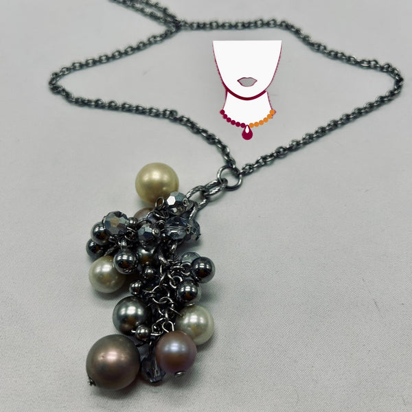 Necklace with black and silver beads on a light gray background