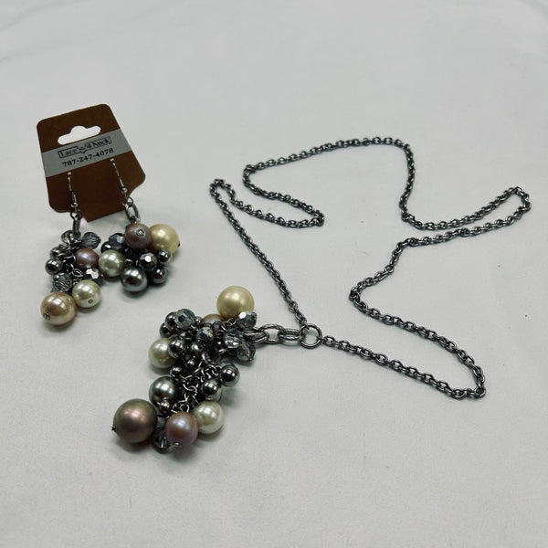 Necklace with pearl and metal bead cluster on a white background
