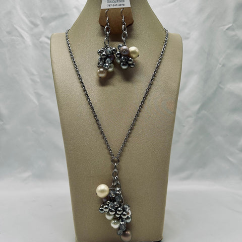 Necklace with pearl and silver bead decorations on a mannequin bust against a white background