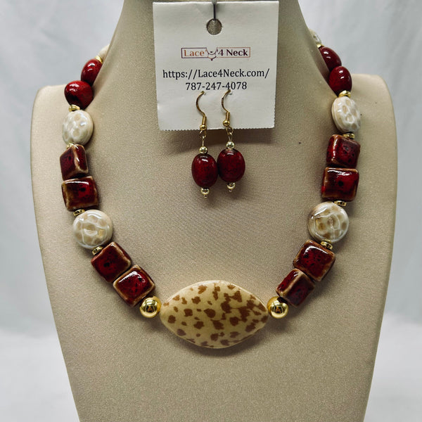 Necklace and earrings set on a mannequin with a visible brand tag.