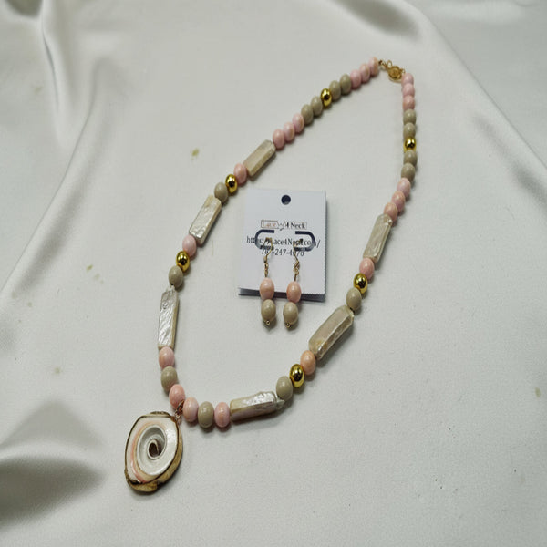 Necklace with pink and gold beads on a white background
