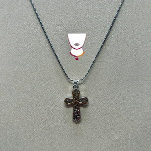 Cross pendant necklace on a gray background