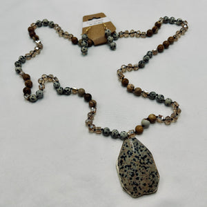 Necklace with a large pendant and beaded chain on a white background