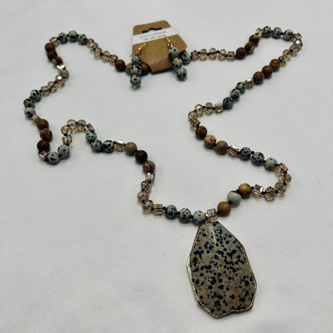 Necklace with a large pendant and beaded chain on a white background