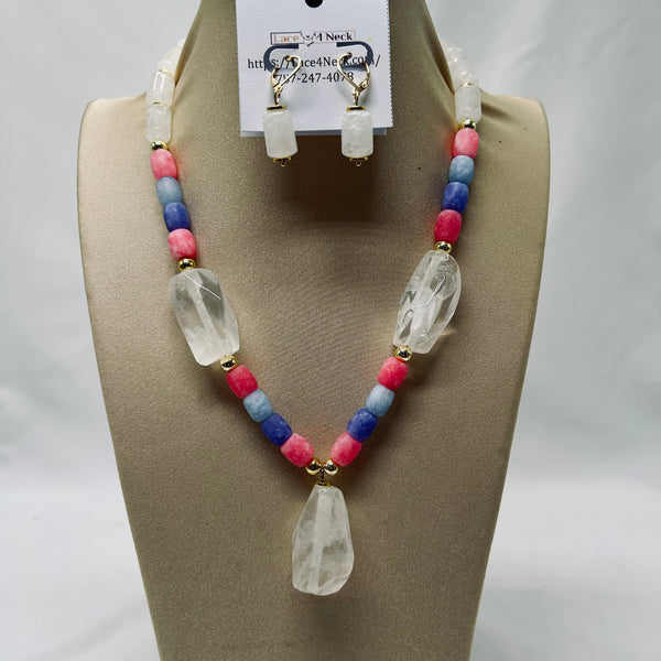 Necklace and earrings set on a mannequin bust with a visible brand tag.