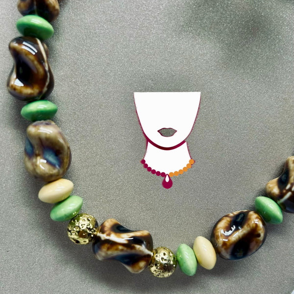 Necklace with assorted beads on a gray background