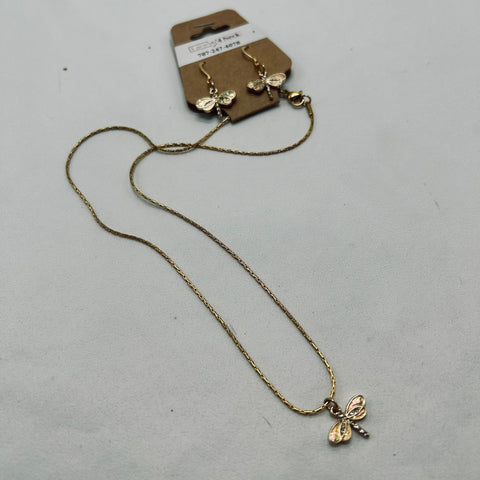 Gold necklace with butterfly pendants on a gray surface