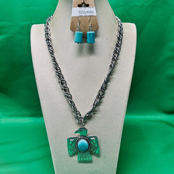 Jewelry set with necklace and earrings on a mannequin bust against a green background