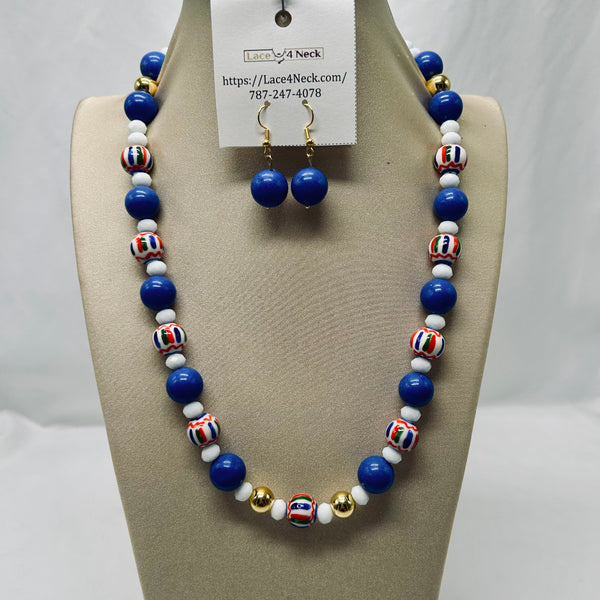 A beaded necklace and matching drop earrings displayed on a beige jewelry bust. The necklace features glossy royal blue beads, white beads, striped multicolor accent beads, and small gold spacer beads.