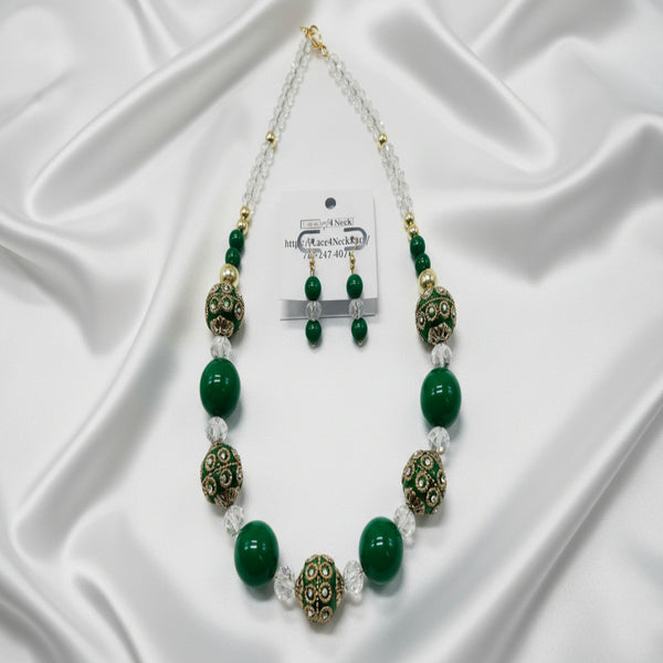 Necklace with green beads and decorative elements on a white background