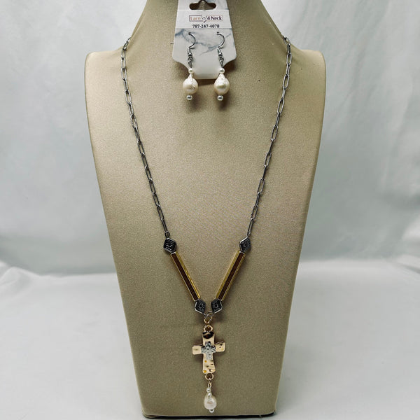 A silver chain necklace with a cross pendant and matching drop earrings displayed on a beige jewelry bust. The necklace features gold-toned rectangular links, dark faceted beads, and a small gold cross with a white pearl dangle.