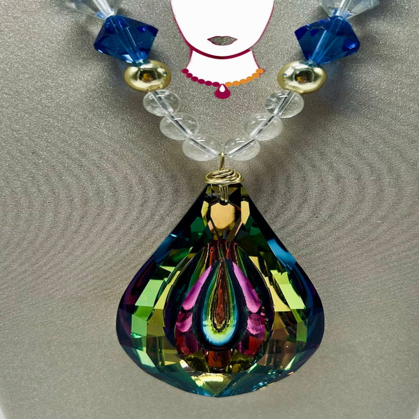 Multicolored teardrop pendant with beads on a gray background
