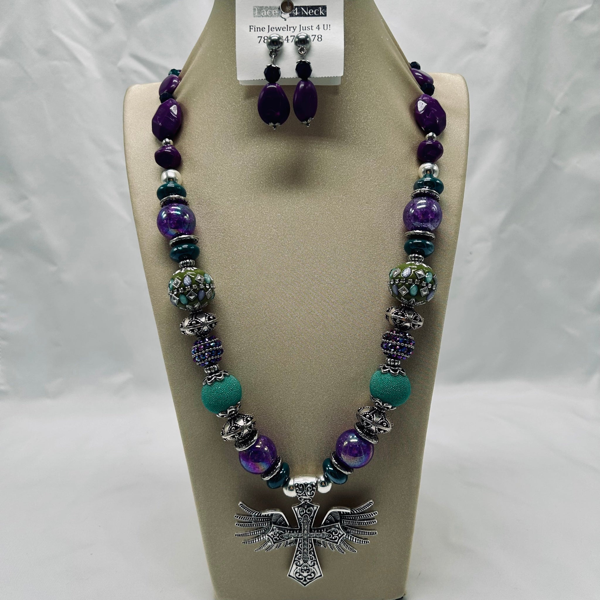 Jewelry set with necklace and earrings on a display stand