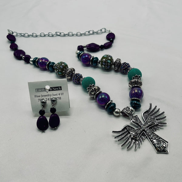 Jewelry set with necklace, earrings, and cross pendant on a white background