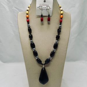 Beaded necklace and earrings set on a mannequin bust with a white background