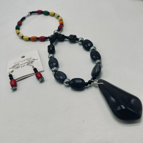 Necklace with colorful beads and a large black pendant on a white background