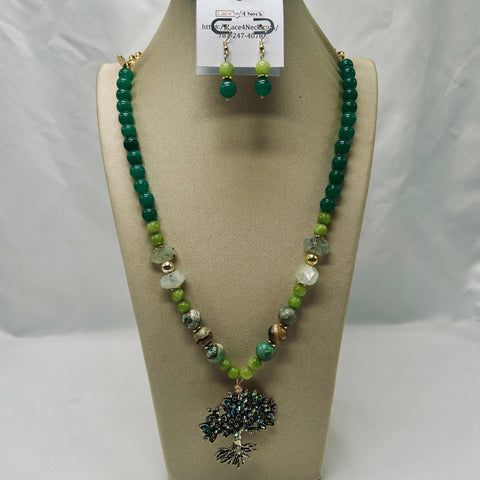 Green beaded necklace with a pendant on a mannequin bust against a white background