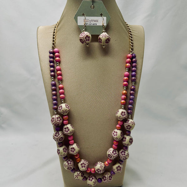 Jewelry set with necklace and earrings on a mannequin bust against a white background