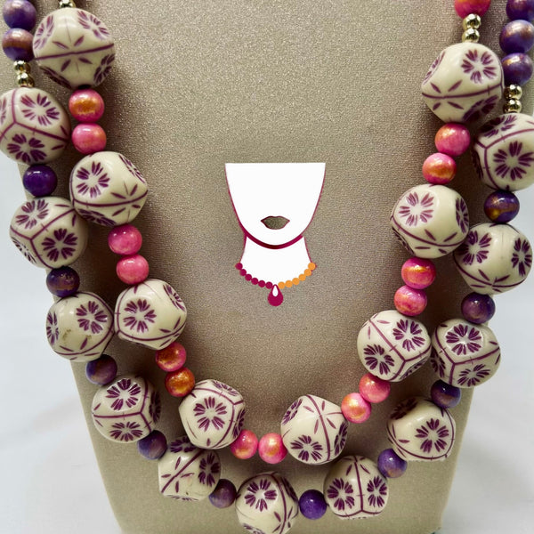 Necklace with patterned beads on a beige card