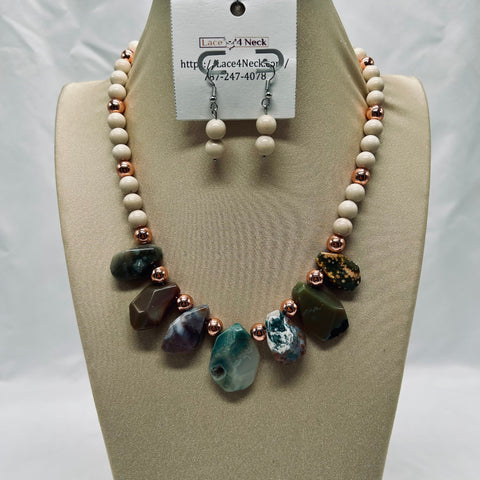 Necklace and earrings set on a mannequin bust with a visible brand tag.
