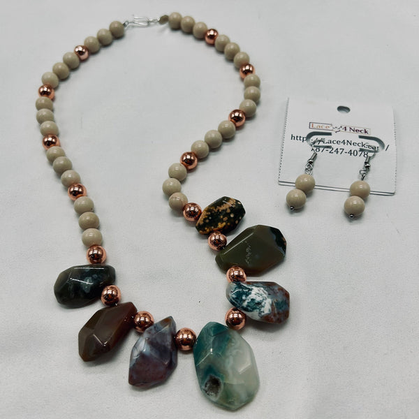 Necklace with natural stone beads and copper accents on a white background
