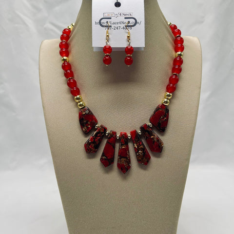 Red beaded necklace and earrings on a mannequin bust with a visible brand tag.