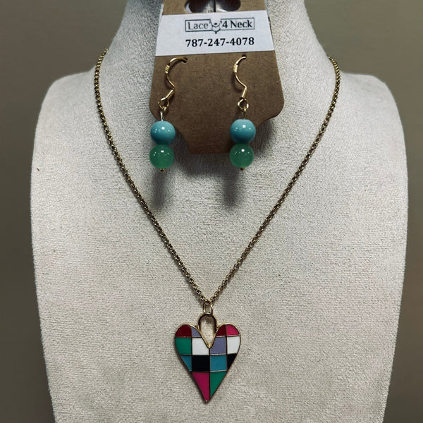 Necklace with a multicolored heart pendant on a mannequin bust with earrings above.