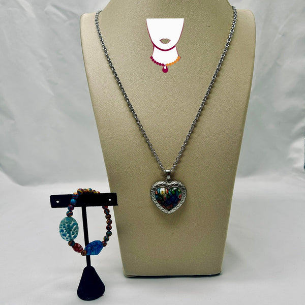 Heart-shaped pendant necklace on a beige display stand with a white background
